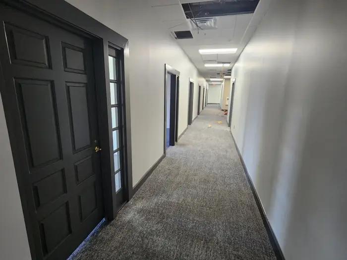 Office corridor with dark doors and new carpet
