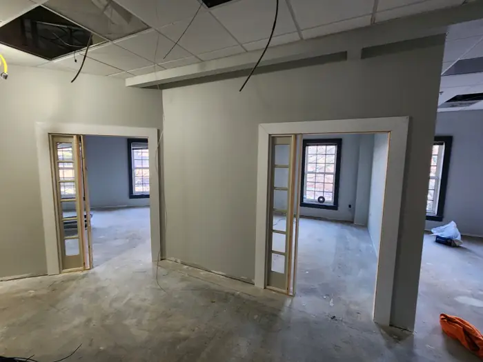 Office walls with door frames being trimmed out