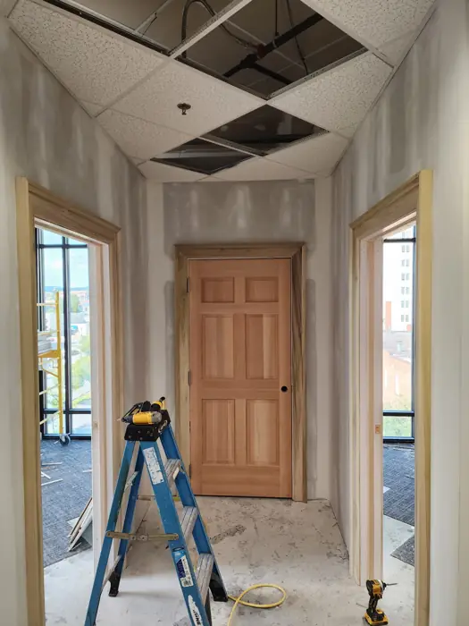 Hallway with wood door, frames and ceiling grid