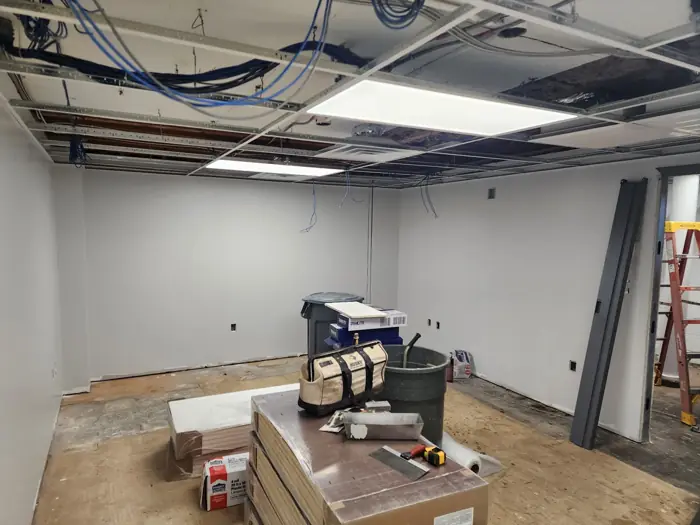 Finished drywall room with ceiling grid going in