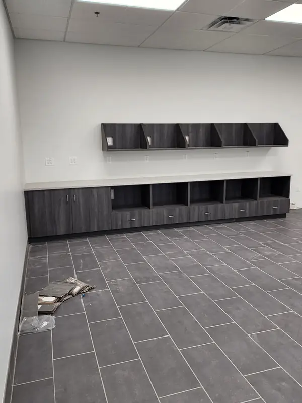 Dark cubby cabinetry and counter over new tile flooring